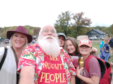 Santa having fun taking selfies with the crowd at a festival in Wisconsin